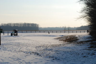 Scenic view of snow covered landscape against sky