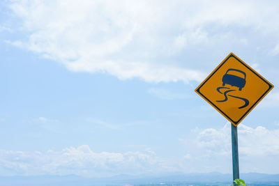 Low angle view of road sign against sky