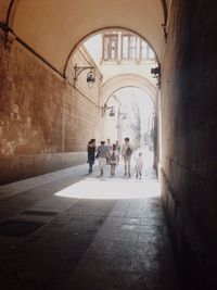 Full length of woman walking in tunnel