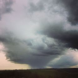 Scenic view of landscape against cloudy sky