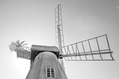 Low angle view of traditional windmill against clear sky