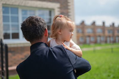 Rear view of friends against blurred background