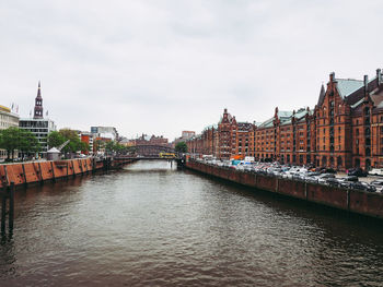 Bridge over river against buildings in city