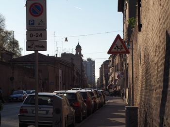 Cars on street amidst buildings in city
