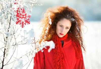 Portrait of a girl with red hair in winter