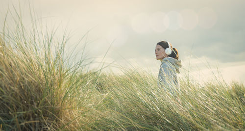 Rear view of woman standing on field