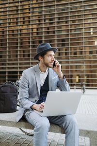 Full length of young man using mobile phone