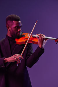 Man playing violin against white background