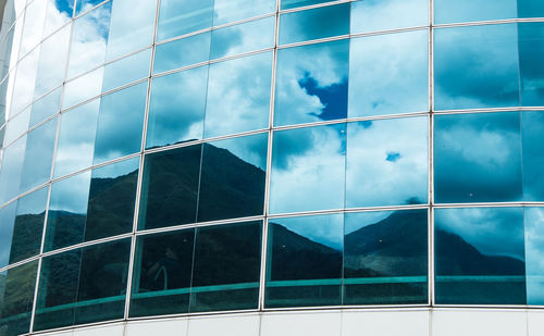 Digital composite image of glass building against sky