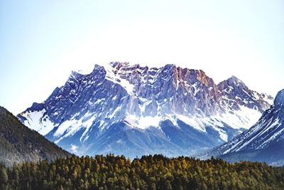 Scenic view of snowcapped mountains against clear sky