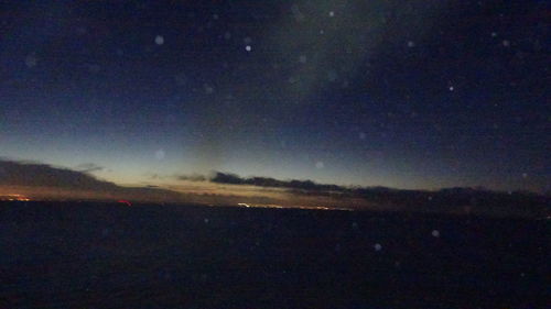 Scenic view of landscape against sky at night