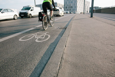 Man riding bicycle on road