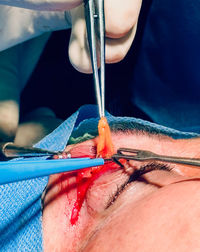Close-up of hand holding syringe