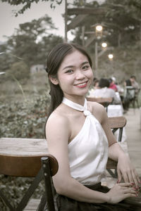 Portrait of young woman sitting on chair