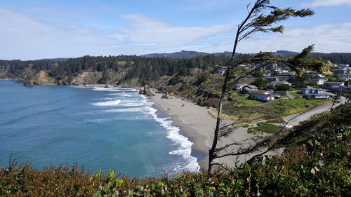 High angle view of buildings by sea against sky