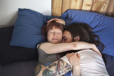 Young couple embracing in bed