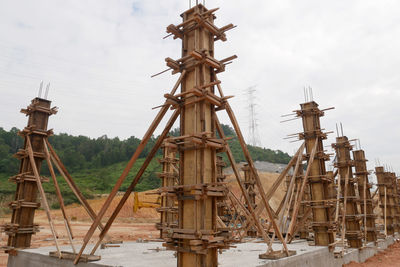 Traditional windmill by building against sky