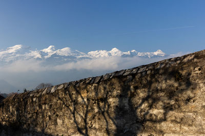 Low angle view of mountain against blue sky