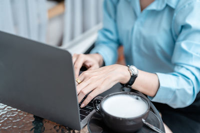 Midsection of man using laptop