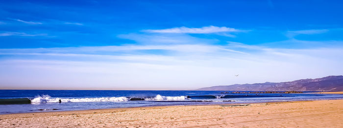 View of beach against cloudy sky