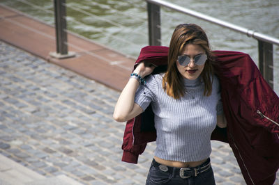 Portrait of young woman standing outdoors