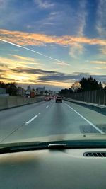 Cars on road at sunset