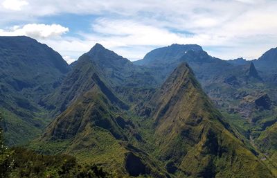 Scenic view of mountains against cloudy sky