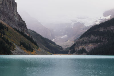 Scenic view of lake and mountains against sky