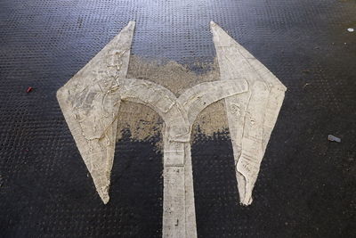 High angle view of arrow symbol on road