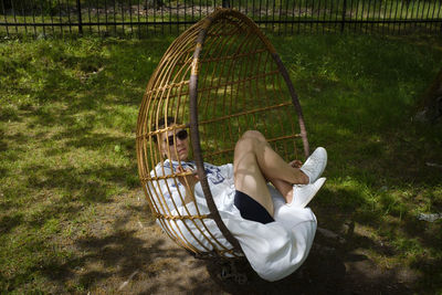 Boy sitting on wicker basket