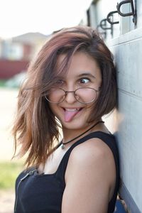 Close-up of happy woman sticking out tongue while making face