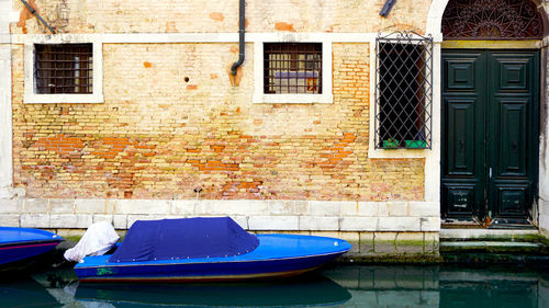 Canal and boats with ancient buildings background in venice, italy, europe