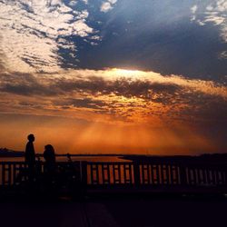 Silhouette of people at sunset