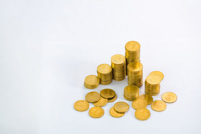 High angle view of coins on white background