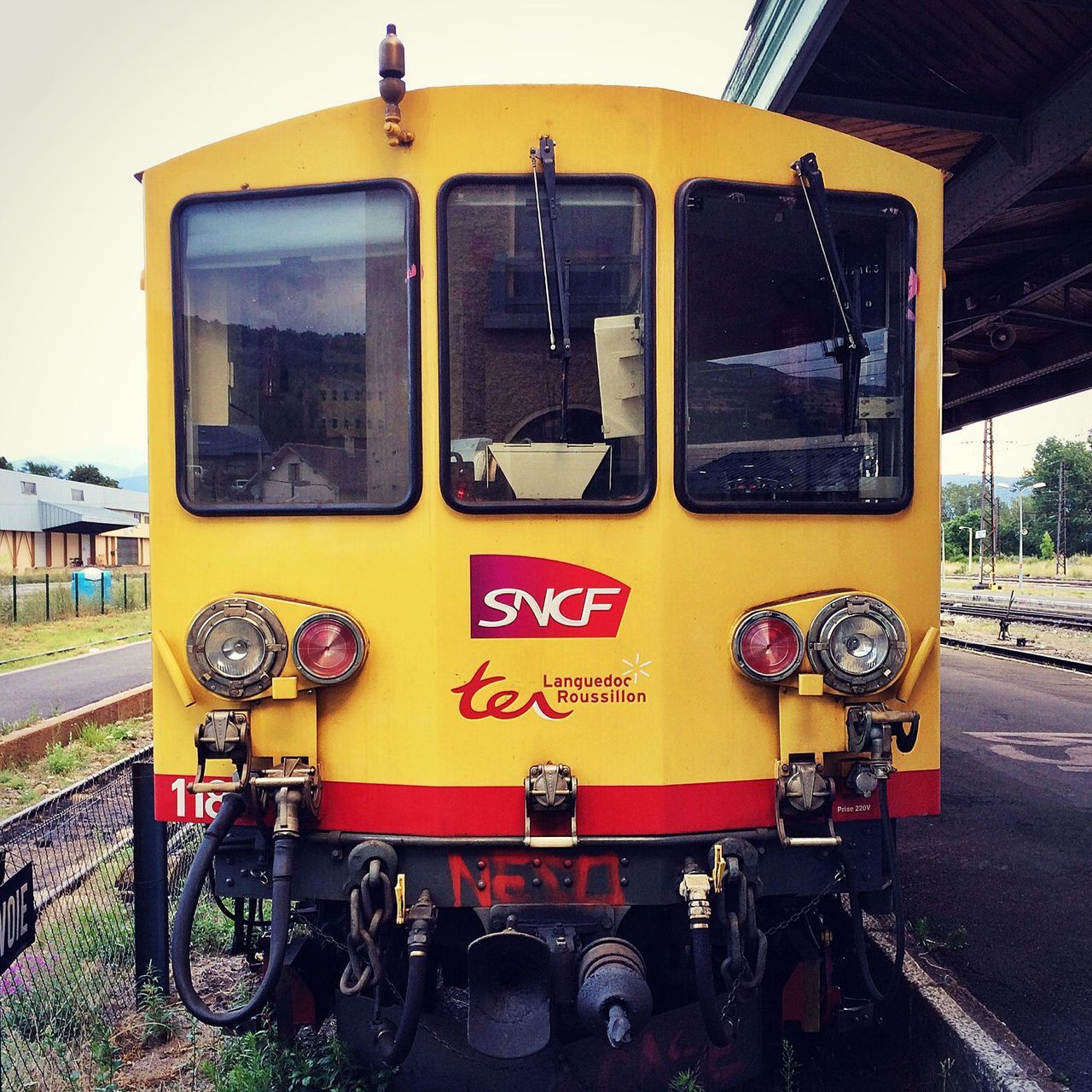 land vehicle, yellow, transportation, mode of transport, technology, car, day, metal, building exterior, built structure, machinery, retro styled, outdoors, communication, old-fashioned, architecture, stationary, travel, train - vehicle, no people