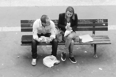 Full length of young woman sitting on book