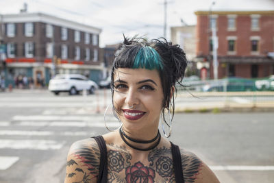 A portrait of a young woman with black and blue hair.