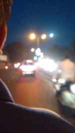 Defocused image of illuminated city street at night