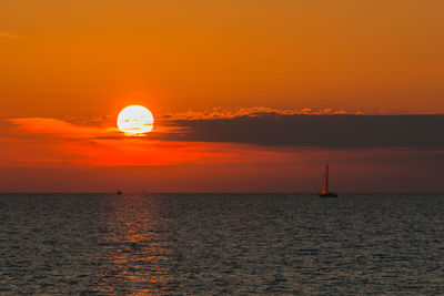 Scenic view of sea against orange sky