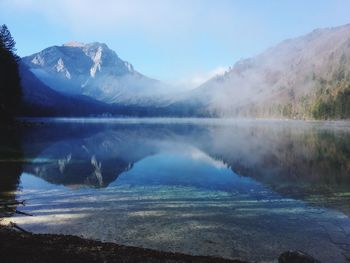 Scenic view of lake and mountains against sky