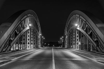 Low angle view of illuminated bridge at night