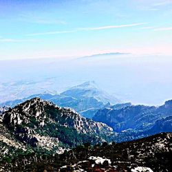 Scenic view of mountains against blue sky