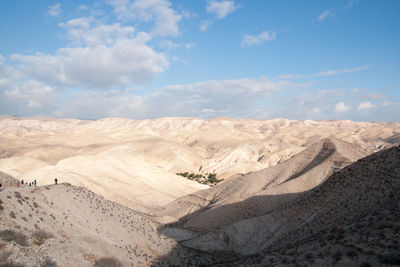 View of desert against cloudy sky