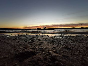 Scenic view of beach against sky during sunset