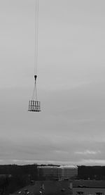 Sailboat hanging on land against sky