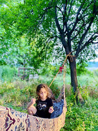 Young woman sitting on hammock