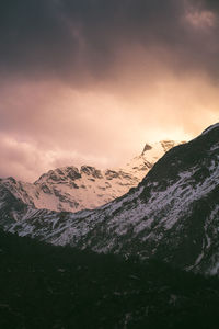 Scenic view of snowcapped mountains against sky during sunset