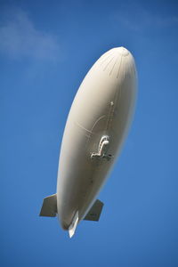 Low angle view of blimp against clear blue sky