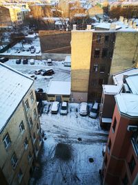 High angle view of snow covered buildings in city