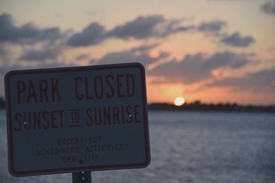 Information sign at sunset